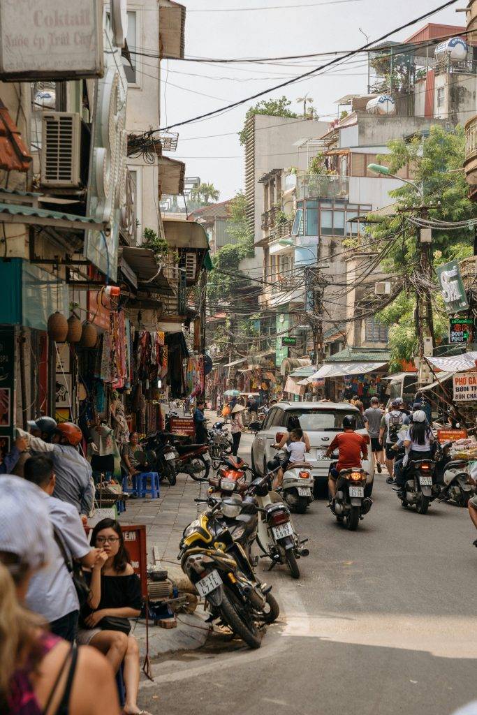 Busy street in Hanoi.Photo by Flo Dahm: https://www.pexels.com/photo/people-sitting-on-sidewalk-1483778/