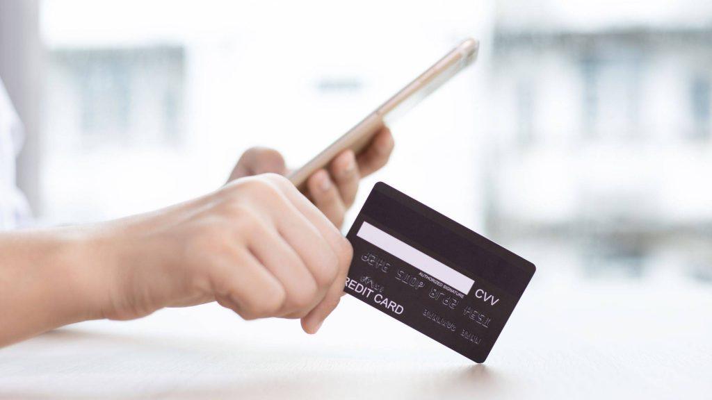 Customer confidently handing over a credit card