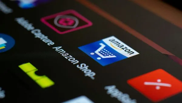 Smartphone screen displaying the Amazon Shopping application icon illustrating digital platform power.